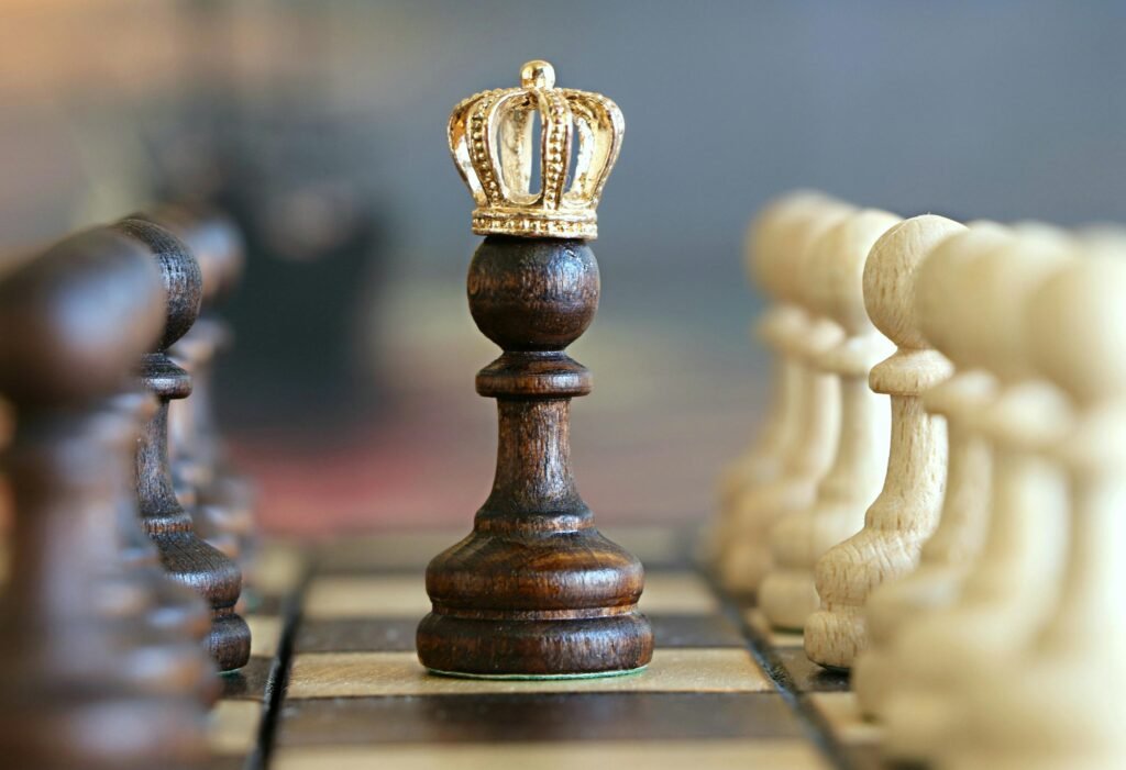 pexels-photo-260024-260024 A brown pawn with a crown stands prominently on a chessboard, symbolizing strategic play.